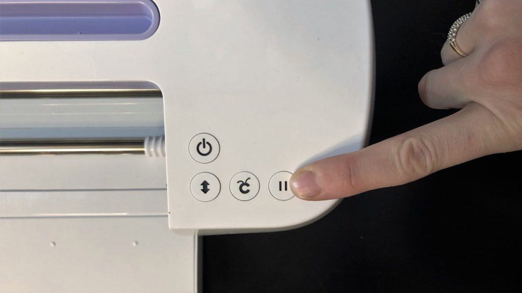 pressing the pause button on a Cricut Maker