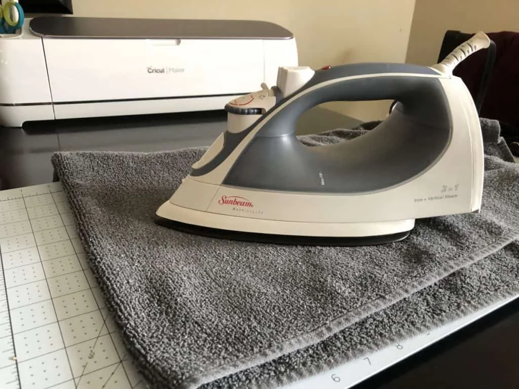 iron on a towel heating a self healing cricut mat